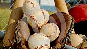 Close up on balls, a glove and bats of baseball