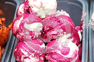 Close-up balls of ice cream in a metal container. blackcurrant ice cream balls in a container.