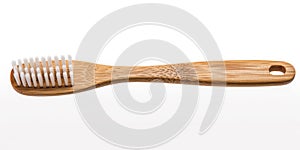 Close-up of a bamboo toothbrush on a white background. Generative ai