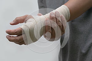 Close-up bandaged wrist men`s pain his hand after work. photo