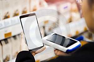 Close up of bar code scanner scanning mobile phone blank screen.