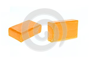 Close up bar of orange carrot soap isolated on white