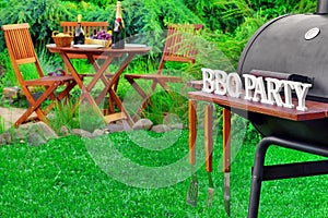 Close-up Of Barbecue Grill With Tools And BBQ Party Sign