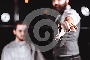 Close up of Barber holding professional equipment tools of Hairdresser -scissors