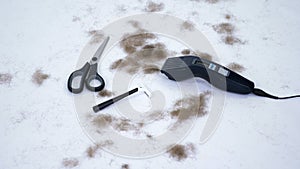 Close up of barber tools and a lot of cut hair from the body, on white background. tools for depilation, hair removal