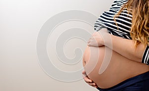 Close up of the bare belly of a pregnant woman