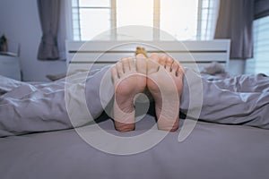 Close up of barefoot,Feet and stretch lazily on the bed after waking up