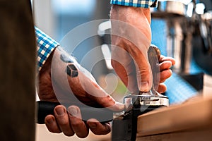 Close Up Of Barista Hands Holding Portafilter With Ground Coffee. Coffee Preparation At Home. Quarantine Time