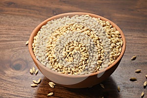 Close up of Barley in a Earthen Bowl on Wooden Background