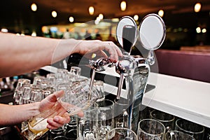 Close up of barman hand at beer tap