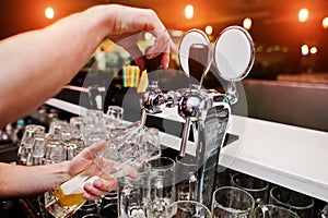 Close up of barman hand at beer tap