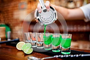 Close-up of bartender hand pouring alcoholic drink