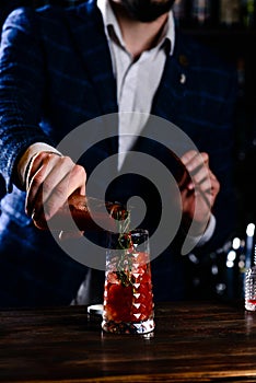 The bartender is preparing a cocktail