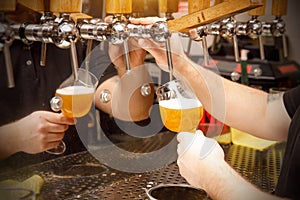 Close-up of bartender pouring draft beer in glass