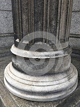 A Close Up Of The Base Of A Stone Column