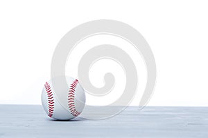 Close up of baseball ball on grey wooden floor. Online workout concept