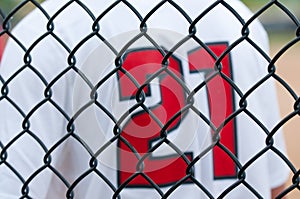 Close up of baseball fence with jersey