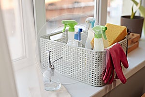 Close Up of Basket with Cleaning Supplies By Window