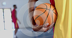 Close-up of a basketball held by an African American man