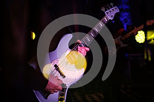 Close-up of a bass guitar during a concert performance