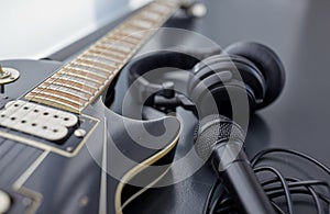 close up of bass guitar, microphone and headphones