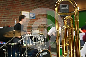 Close-up of a bass trombone tube with a fourth and fifth valve. Whorls in golden brass metal. Jazz trombones detail view with