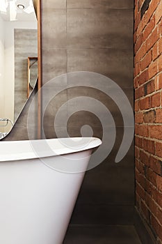 Close up of bath end against grey tiled wall background photo