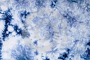 Close-up batik shirt with indigo blue dye on white fabric cotton background