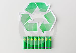 Close up of batteries and green recycling symbol