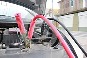 Close-Up of Battery jumper cables to car battery