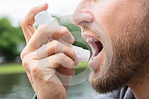 Man Using Asthma Inhaler photo