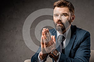 close up of bearded businessman sitting in armchair with