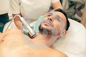 Oxygen meso therapy of the young bearded man photo