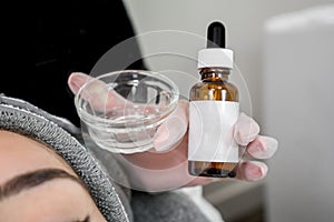 Close up of beautician cosmetologist applying chemical peel treatment on patient in a beauty spa, for skin rejuvenation,