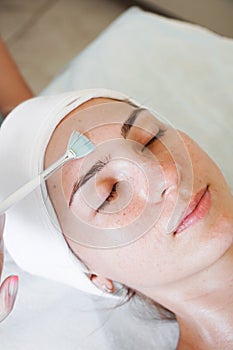 Close-up beautician doctor hand making anti-age procedure apply peeling acid