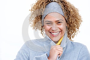 Close up beautiful african american woman smiling with winter coat and headband by white background