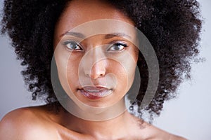 Close up beautiful african woman with curly hair and naked shoulders