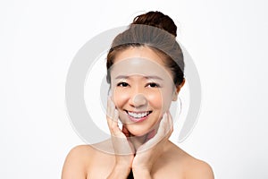 Close up of a beautiful asian woman`s face. She smiles with clean skin