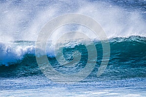 Close up of beautiful and bigs blue and green waves breaking - pacific or athlantic ocean - blue sea and great place to surf