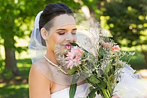 Close-up of a beautiful bride with bouquet in park