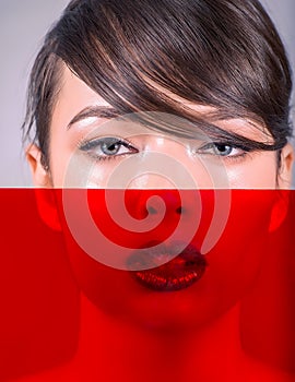 Close-up of a Beautiful Caucasian Woman With Cat Blue Eyes, Full Lips and Open Mouth, With Red Filter on Nose and Mouth, on Grey