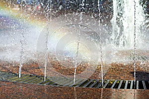 Close up of beautiful city fountain. Splashing upward crystal thin streams of clear cool transparent water, shiny droplets. Multic