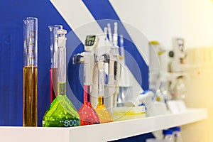 Close up of beautiful colorful chemistry liquid in various laboratory flask on shelves for science