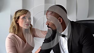 Close-up of a beautiful couple, an African-American man and a pretty woman with red lipstick on their lips, they are