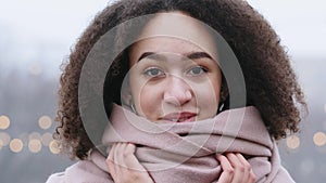 Close-up beautiful female face with natural make-up, portrait African American young girl with curly hair stands on