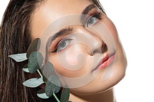 Close up of beautiful female face with organic treatment over white background. Cosmetics and makeup, natural and eco