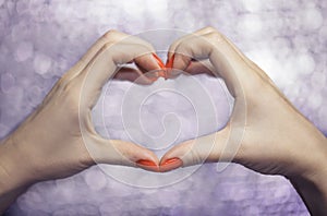 Close up on beautiful female hands with Red manicure in shape of love heart