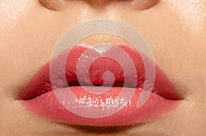 Close up beautiful female lips with pink lipgloss