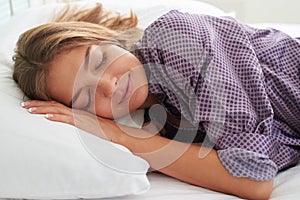Close-up of beautiful female sleeping on white pillow