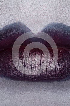 Close up of beautiful full woman lips with purple makeup